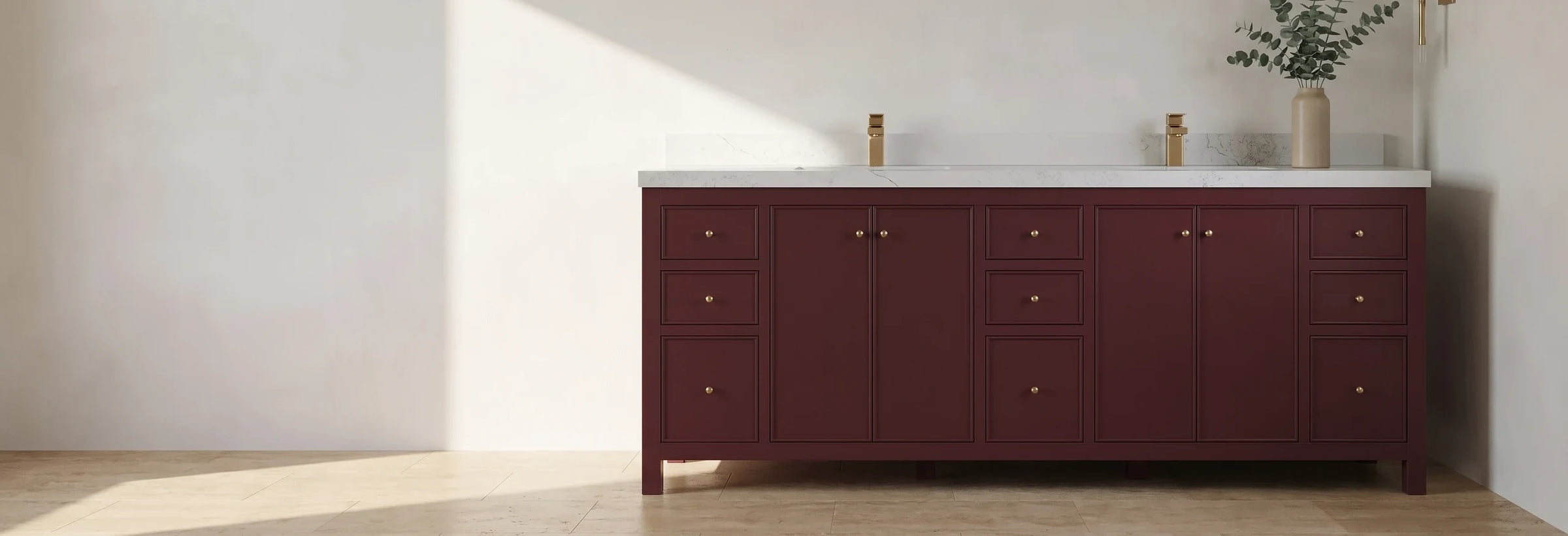 Chicago 84 in. double-sink bathroom vanity in deep burgundy with brushed brass knobs, in a sunlit travertine bathroom