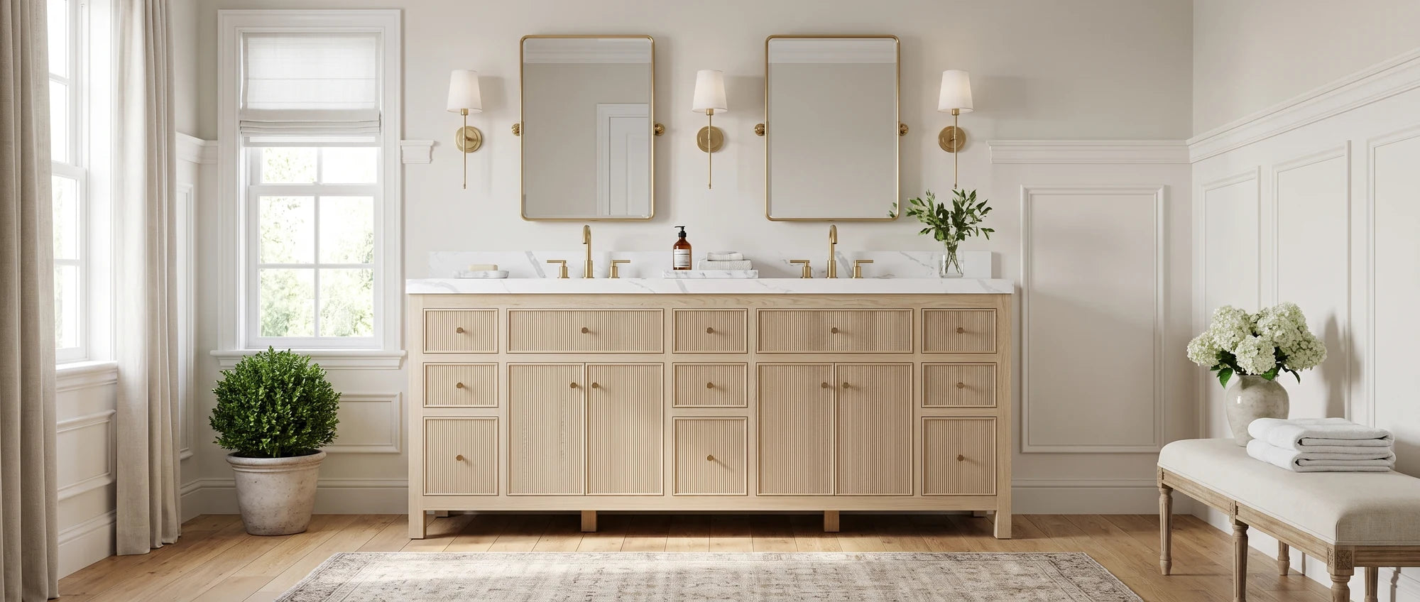White Oak bathroom vanities — American transitional bathroom with a reeded white oak double-sink vanity, brushed brass fixtures and marble top