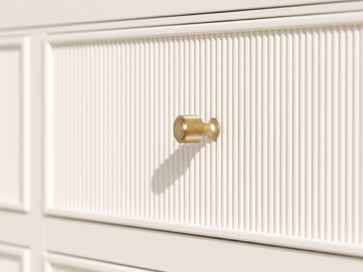 Sonoma Alabaster vanity detail showing the textured brass knob, narrow frame and finely reeded front