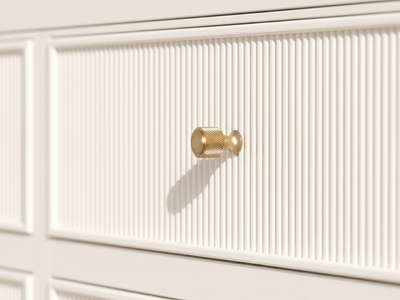 Sonoma Alabaster vanity detail showing the textured brass knob, narrow frame and finely reeded front