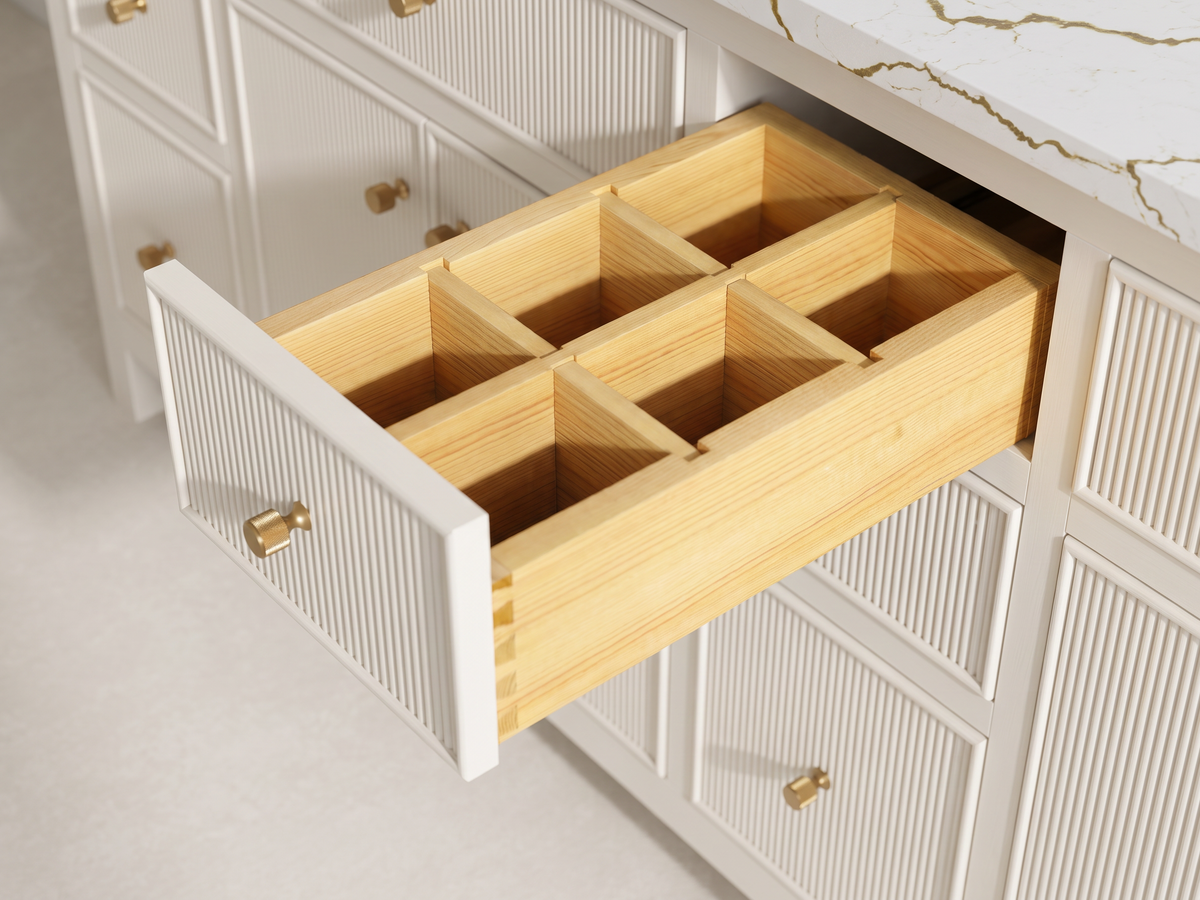 Sonoma Alabaster vanity detail showing the six-compartment wooden drawer organizer, dovetail joints and textured brass knob