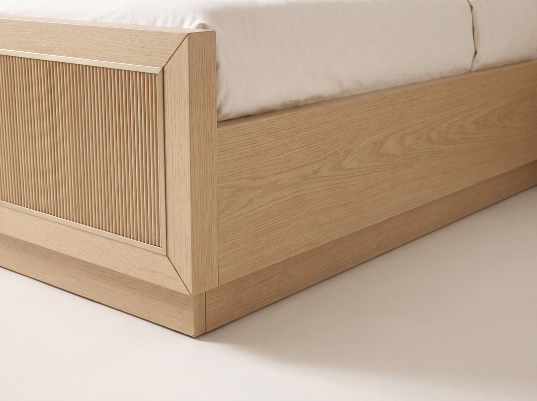 Studio detail render of the Sonoma bed: a closed floor-level White Oak plinth and the horizontal separation seam along the side.