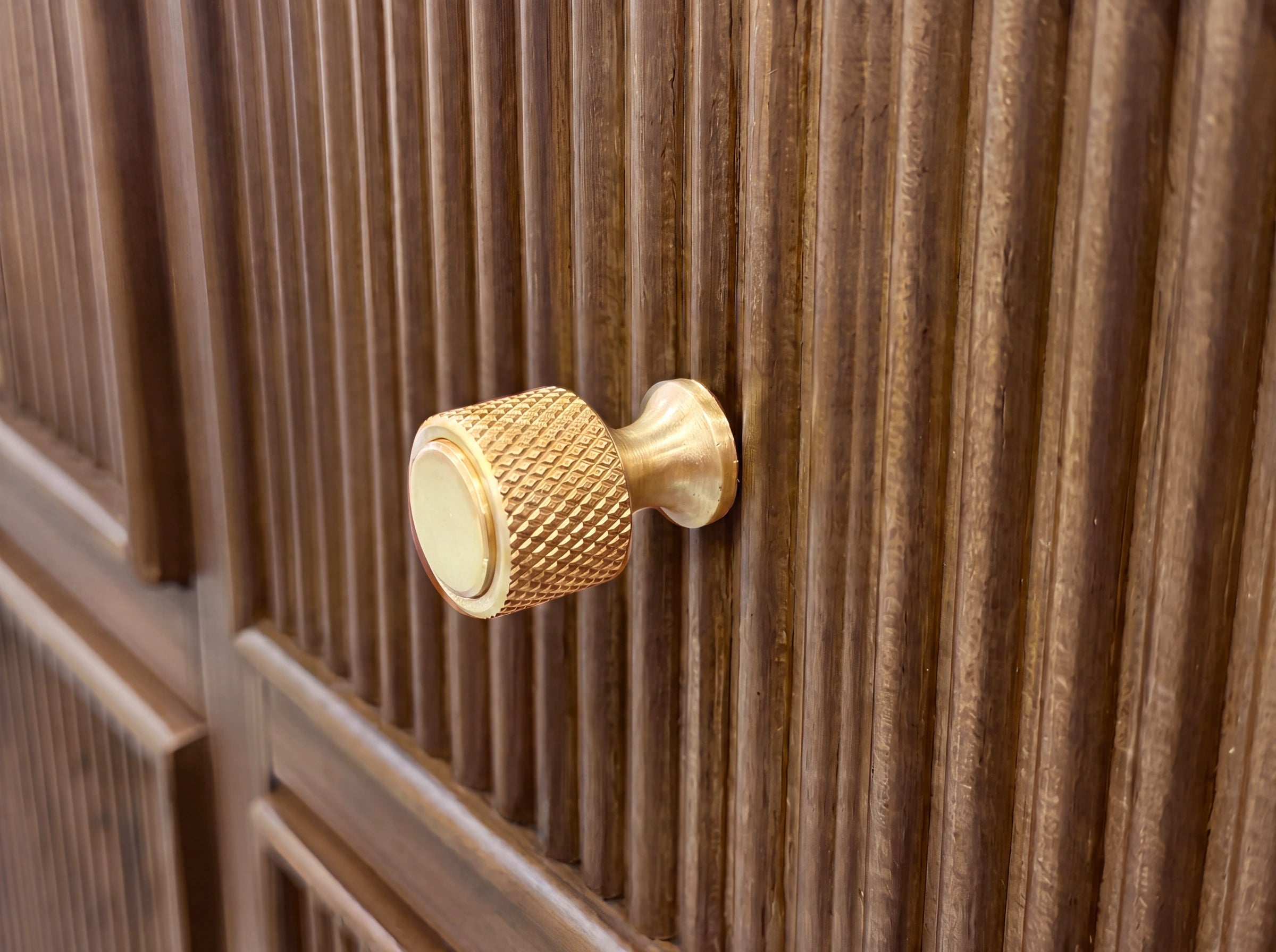 Close-up of Sonoma Dark Natural teak vanity, showing a knurled gold-tone knob and reeded wood detail