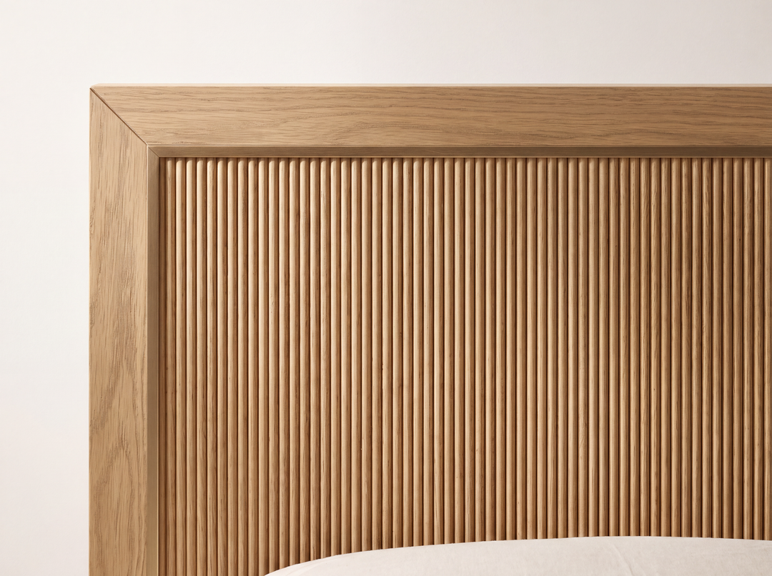 Studio detail render of the Sonoma bed: White Oak grain, fine vertical reeding and a square mitered headboard frame.