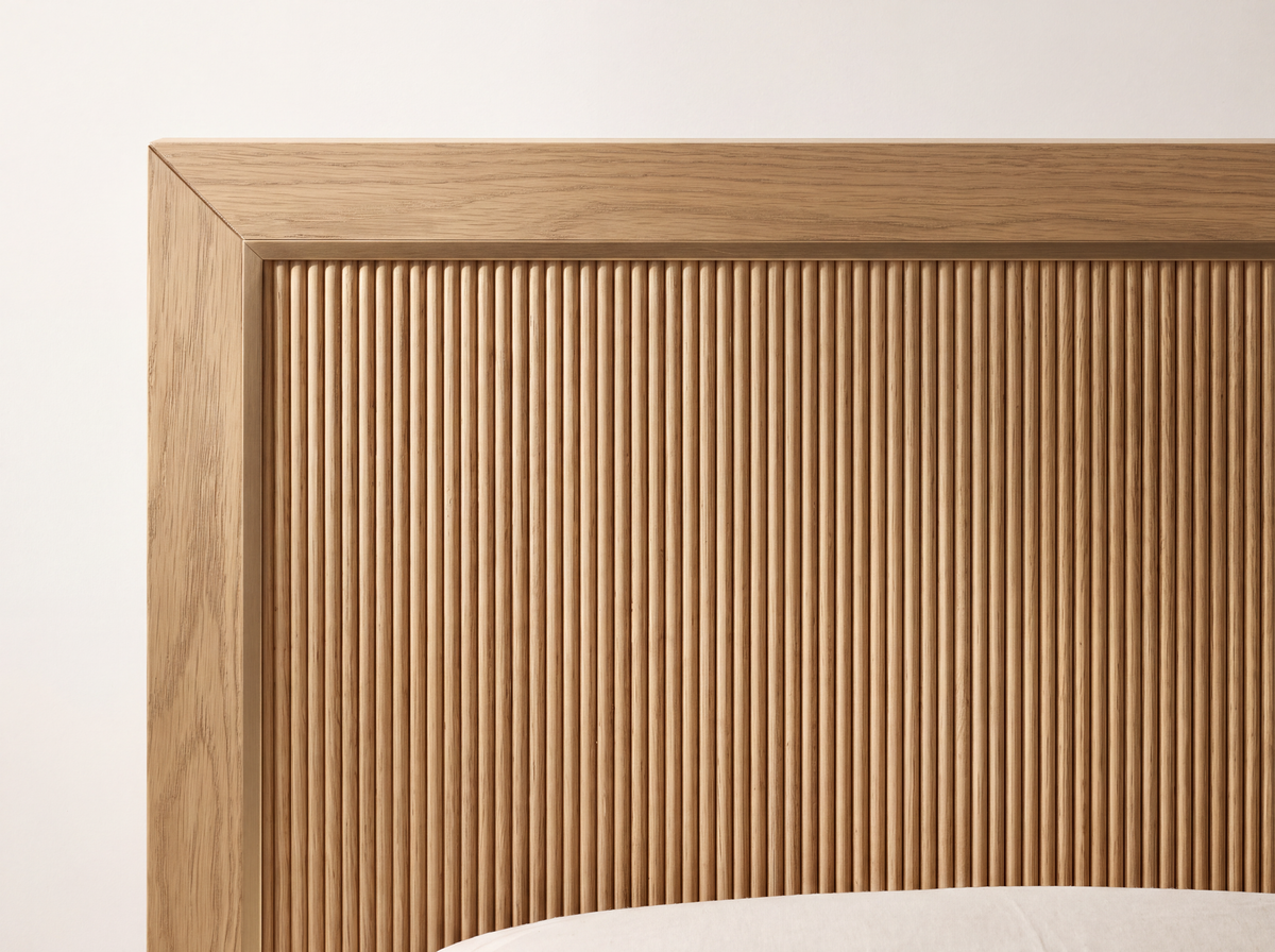 Studio detail render of the Sonoma bed: White Oak grain, fine vertical reeding and a square mitered headboard frame.