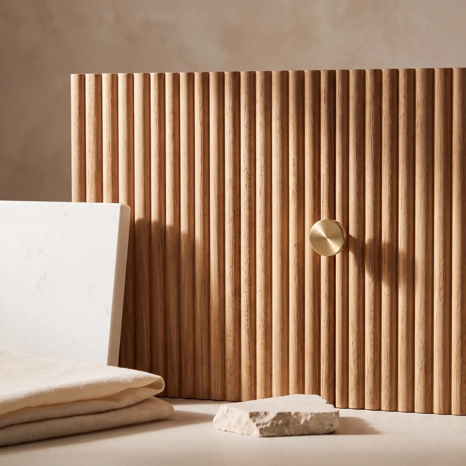 Fine vertical Light Natural Teak reeding, brushed brass hardware, honed stone and warm linen materials